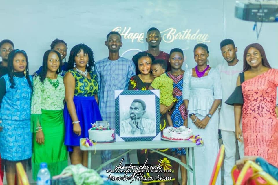 A group celebrating Pastor Popoola